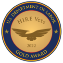 Gold outlined badge seal with the words U.S. Department of Labor Gold Award inside of a circular frame. In the middle, an image of the outline of a golden eagle with the words Hire Vets 2022